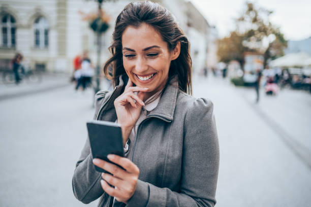 istock Woman using smartphone outdoors. 1336531049