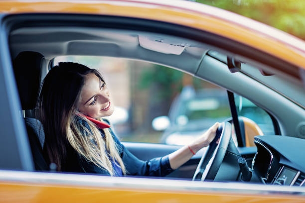 istock Young woman is using mobile phone in a traffic jam 1336531331