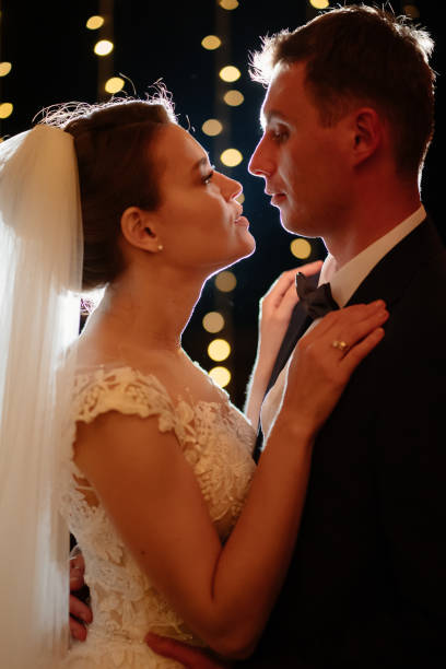 istock bride and groom at evening wedding ceremony in park among light bulbs 1336532099