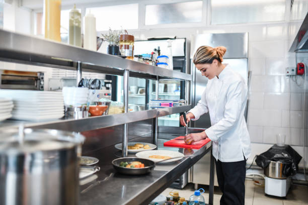 istock Beautiful Female Cook Preparing Special Dish In Restaurant Kitchen 1336532351