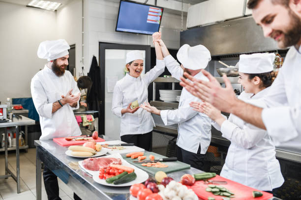 istock Smiling Female Cook Getting Praised By Colleagues After Winning Vegetable Cutting Competition 1336533017