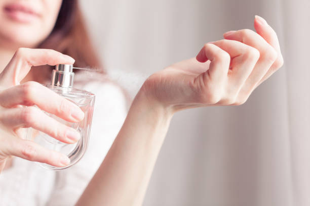 istock girl sprays herself perfume on her wrist 1336539308