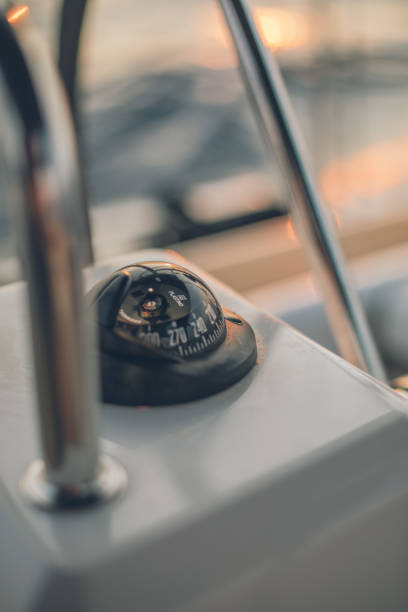 istock Nautical compass on boat at sea at sunset 1336539696