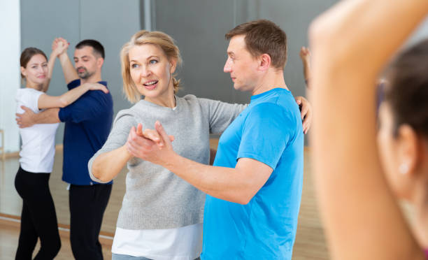 istock Middle aged woman learning to dance waltz 1336540770