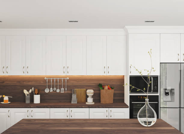 istock Walnut wooden island in white luxury kitchen 1336542169