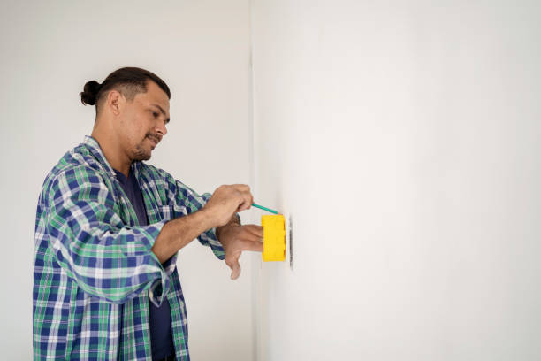 istock Electrician marking drywall for clipping 1336543682