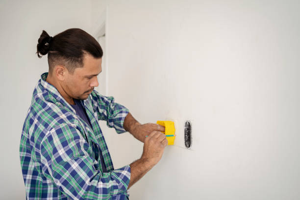 istock Electrician marking drywall for clipping 1336543684