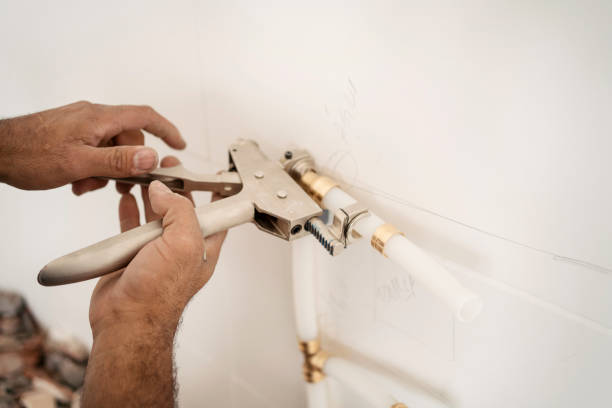 istock Close up of the plumber's hand installing pipes on the kitchen wall. 1336543762