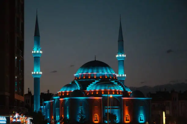 24.07.2021. Konya. Turkey. Blue lights on mosque and long exposure photo of cars on city and center of Konya at night.