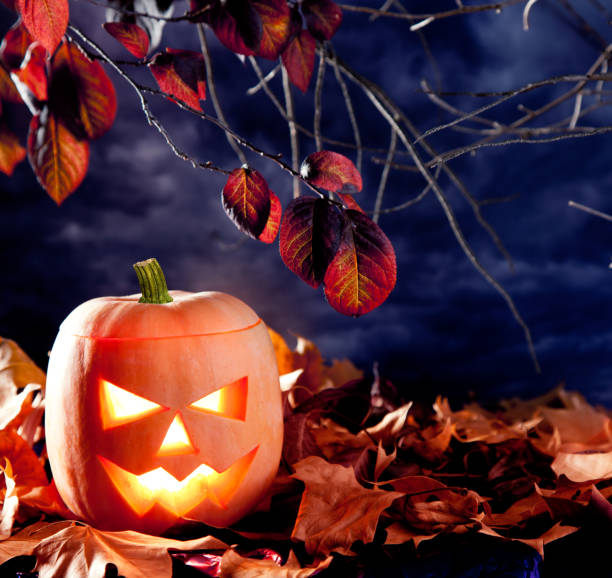 istock halloween lantern pumpkin  in dark sky clouds 1336547326