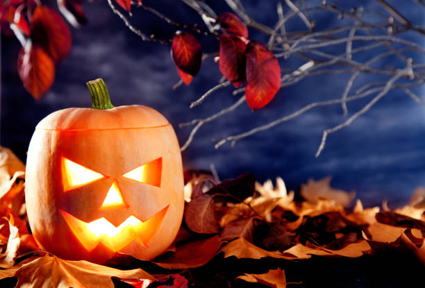 istock halloween lantern pumpkin  in dark sky clouds 1336547334