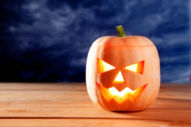 istock halloween lantern pumpkin  in dark sky clouds 1336547342