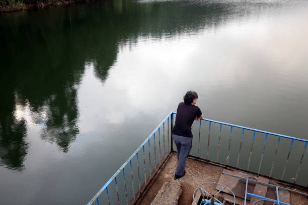 istock a man  stands on pier looking away 1336547573