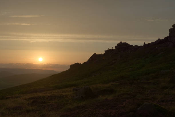 istock Wide angle sunset at stanage edge, with many people outdoors at sunset 1336547645