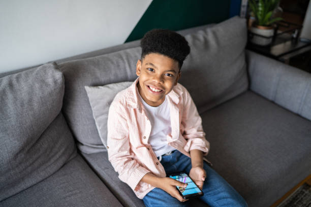 istock Portrait of a boy using a smartphone at home 1336548391