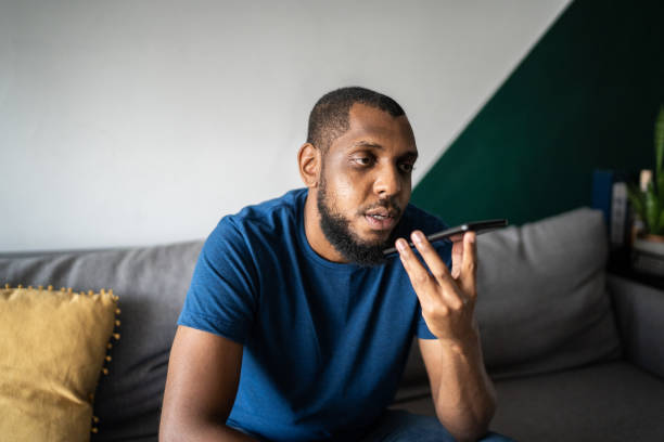 istock Man sending audio message on smartphone at home 1336548425