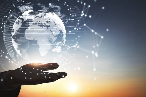 istock Close up of backlit hand holding abstract glowing polygonal globe on blurry sunset background with mock up place. Network, communication and global innoovation concept. 1336548630
