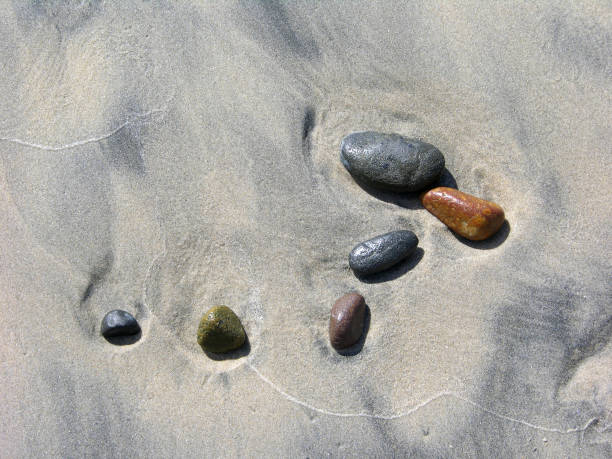 istock Small Rocks On Wet Beach Sand 1336548869