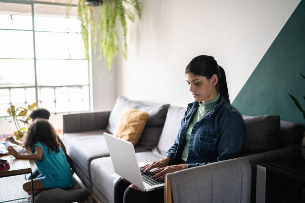 istock Woman using laptop at home 1336549009