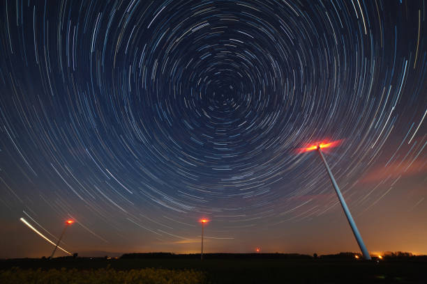 istock Windmill against startrail. Starry night moody picture. 1336549810