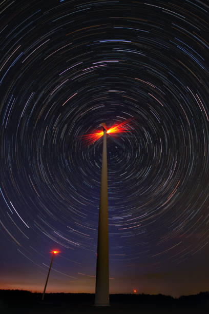 istock Windmill against startrail. Starry night moody picture. 1336549814