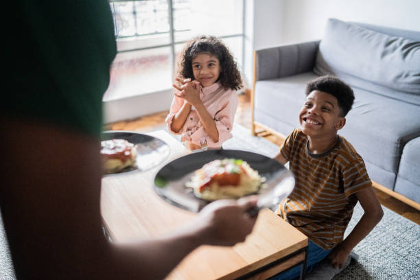 istock Father serving pasta to children at home 1336549912