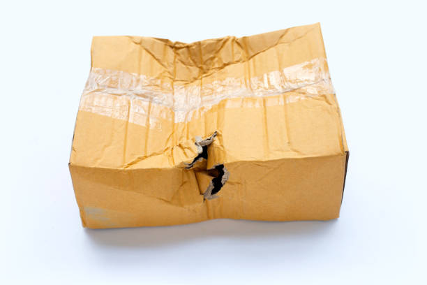 istock Damaged cardboard box with hole 1336550630