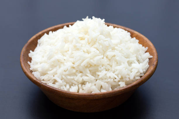 istock Bowl of rice on dark background. 1336550713