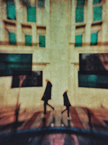 Multiple exposure blurred view of a man walking on the street.