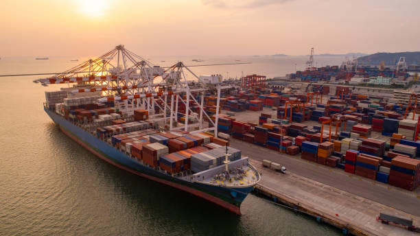 istock Container ship in export and import business and logistics. Shipping cargo to harbor by crane. Water transport International. Aerial view and top view. 1336552187