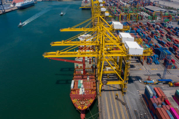 istock Container ship in export and import business and logistics. Shipping cargo to harbor by crane. Water transport International. Aerial view and top view. 1336552190