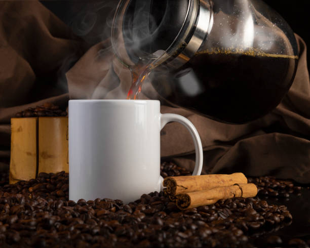 istock 11 oz White Glossy Mug Mockup with coffee beans on dark background 1336552481