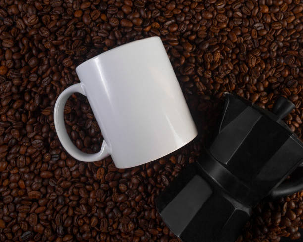istock 11 oz White Glossy Mug Mockup with coffee beans on dark background 1336552483