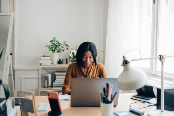 istock Cheerful Business Woman Working from Home on Laptop Computer 1336556412