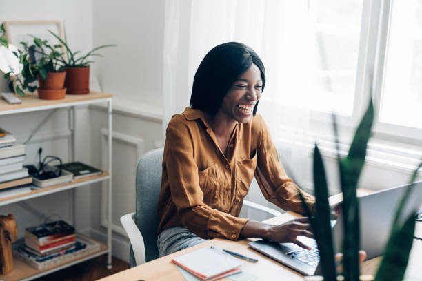 istock Cheerful Business Woman Working from Home on Laptop Computer 1336556422