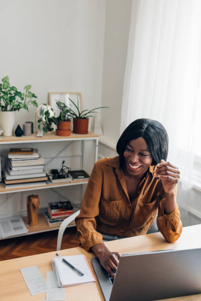 istock Cheerful Business Woman Working from Home on Laptop Computer 1336556429