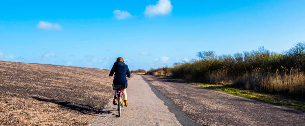 istock Panorama Woman rides a Bike 1336558170