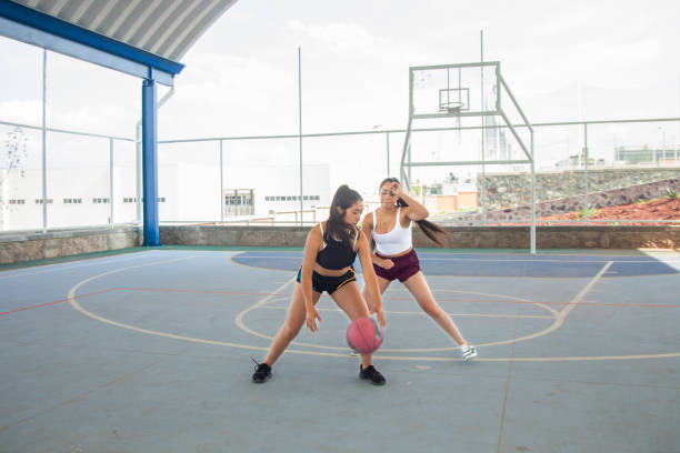 istock Young women playing basketball 1336561096