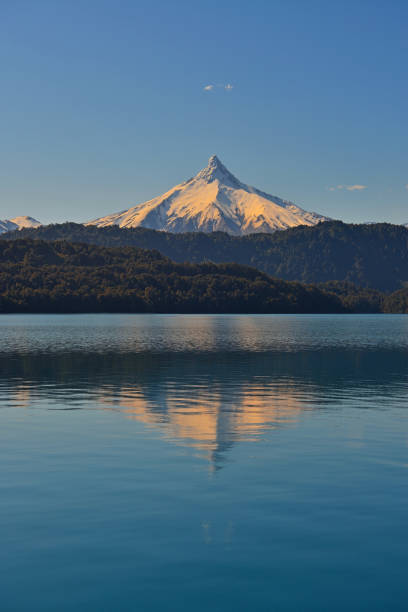 Reflection of the Puntiagudo volcano at sunset, All Saints Lake, Chile.