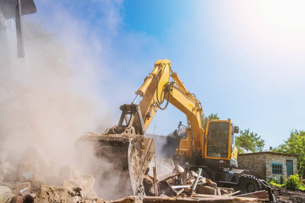 istock Excavator breaks old house, many dust in air. Building demolition and deconstruction, copy space 1336562199