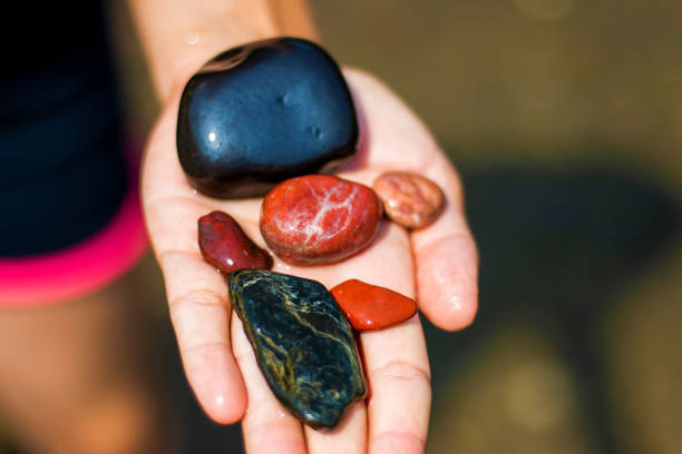 istock Woman is holding a stones in hand 1336570456