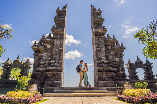 Loving couple of tourists in budhist temple Brahma Vihara Arama Banjar Bali, Indonesia. Honeymoon.