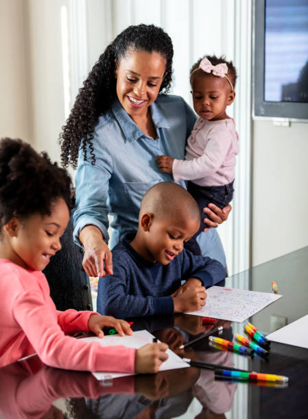 istock African-American mother, hands full with three children 1336579609
