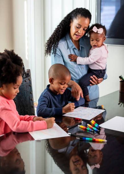 istock African-American mother, hands full with three children 1336579612