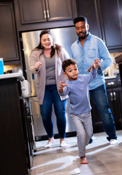 istock Multi-ethnic family in kitchen, boy leaving with frown 1336579709