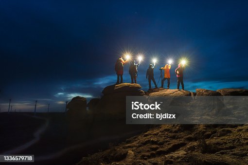 istock A group of night sky photographers stand on the stone with lamp at night 1336579718