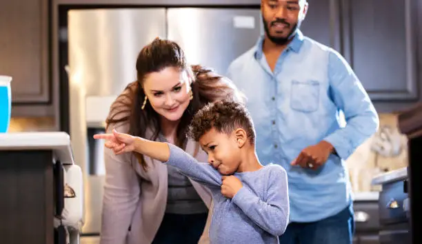 Photo of Multi-ethnic family, boy pointing at something he wants