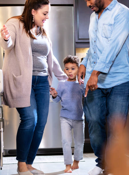 istock Multi-ethnic family with boy standing in kitchen 1336579748