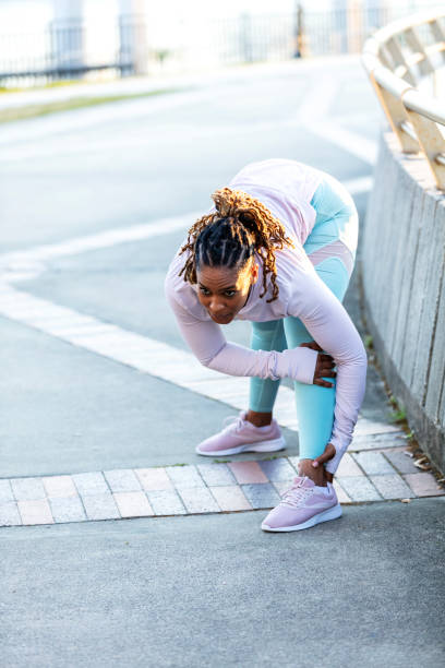 istock African-American woman doing warm up exercises, bending 1336580449