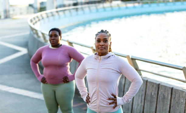 istock Two African-American woman exercising outdoors, warm up 1336580464